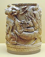 Ancient Greek ivory pyxis with griffins attacking stags. Late 15th century BC