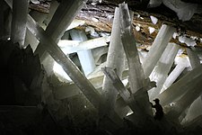 Gypsum crystals in the Cave of the Crystals in Mexico (person at lower right for scale)