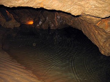 A still body of water completely enclosed in a cave.