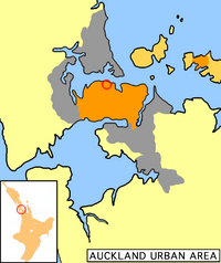 Auckland City's urban areas (in orange) within the greater Auckland urban region (grey). The city centre is ringed. Auckland City also encompassed islands of the inner (upper right) and outer Hauraki Gulf.