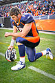 American football player Tim Tebow "tebowing" as genuflection (kneel/squat combination).