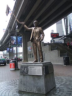 A statue of Neilson waving a towel on the end of a stick outside a sports stadium
