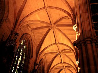 The aisles have ribbed stone vaulting with carved bosses