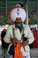 An Akali Singh wearing many Aad Chands in Amritsar and holding prayer beads