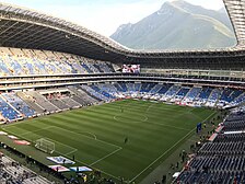 View of Cerro de la Silla from inside Estadio BBVA. It is a soccer stadium with a large mountain standing over the stadium.