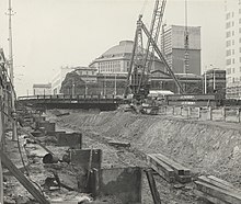Construction of Museum station in July 1974, showing cut and cover excavation of La Trobe Street, with the State Library of Victoria in the background.