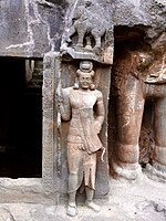 Dvarapala statue guarding a cave.