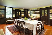 The dining room of the Florence Griswold House in Old Lyme, CT showcasing painted wall panels by 19th century American artist-boarders.