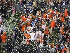 Clemson's coach and players are presented with the championship trophy.