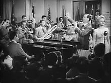Black and white still shot showing musicians performing