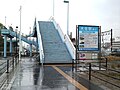 The sign says "Ōzai Station South Entrance". This footbridge leads to the forecourt next to the station building on the other side of the tracks.