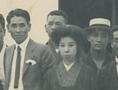 Three men and a woman stand for a photograph, including Tsuburaya who is wearing a white hat