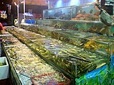 Cantonese often run seafood restaurants by the sea, using fish tanks such as those pictured to keep the seafood. It is a common sight in Lingnan.