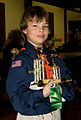 Image 3A happy Cub Scout holds a winning pine car