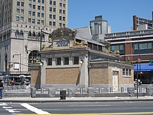 View of the former control house from Fourth and Atlantic Avenues. The control house is a one-story building with a brick facade and gable roof.