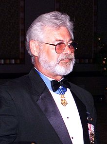 Sergeant Major Jon R. Cavaiani proudly displays his Medal of Honor at the Marine Corps Law Enforcement Foundation's 10th Annual Gala on 12 June 2004.