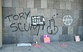 "Tory scum" graffitied on a wall of 30 Millbank (then home to Conservative Campaign Headquarters) during the 2010 student protests in London