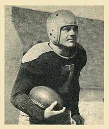 Schlinkman in uniform running with a football