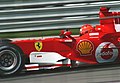 Michael Schumacher driving the Ferrari 248 F1 at the 2006 United States Grand Prix, showing sponsorship from Vodafone, Shell, and the Marlboro "barcode".