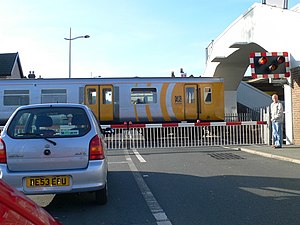 A level crossing at Hoylake, Merseyside, England, with a train passing