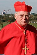 Cardinal Angelo Scola wearing a scarlet watered silk biretta