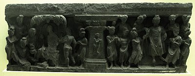 Relief with child depicted at the center, and numerous figures at the sides, including the Buddha