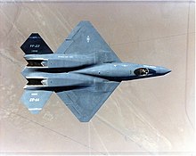 Top view of black jet aircraft, showing trapezoidal wings, engine nozzle, and two-piece tail. The separation between the forward fuselage and engine nacelles is apparent.
