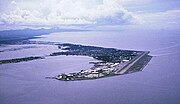 Aerial view of base and Cavite City (c. 1964) on Cavite Peninsula in Manila Bay.