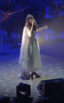 Aimer performing the song "StarRingChild" in a concert with composer Hiroyuki Sawano in 2015