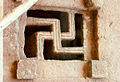 Carved fretwork forming a swastika in the window of a Lalibela rock-hewn church in Ethiopia.