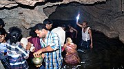 Pilgrims worshipping inside the wet passage (Shwet Ganga) of the Mandhip Khol Chhattisgarh