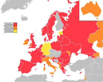 Map of countries in Europe, North Africa and Western Asia, with Australia as an insert in the top-right corner, coloured to indicate the decade in which they first participated in the contest: 2000s in red, 2010s in orange, 2920s in yellow