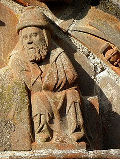 Joseph in the nativity scene in the tympanum over the south porch. He sits at the foot of the Virgin Mary's bed.
