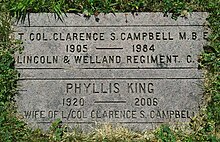 Flat grey granite stone inscribed with the names of Campbell and his wife, with their birth years and death years