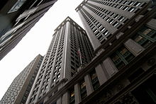 A street-level picture looking up at an imposing building, demonstrating its shadowing effects