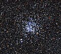 The blue stars in the centre of the image are the young, hot stars of the cluster.[11]