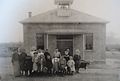 An early photo of the students and the schoolhouse, c. 1910.