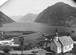 Hellesylt with church late 1800s, Sunnylvsfjorden in the background. Credit: Axel Lindahl