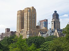 The twin towers of the Majestic apartment building, at the center of the image, as seen from Central Park. The low-rise Dakota apartment building can be seen at right.