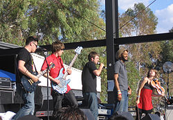 Flobots at KFMA Day in Tucson, Arizona on May 16, 2008. From left to right: Andy Guerrero, Jesse Walker, Jamie Laurie, Stephen Brackett, MacKenzie Gault