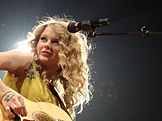 Taylor Swift performing on the Fearless Tour