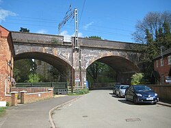 Two of five low blue-brick arches