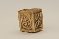 A cubical ivory bead or game piece from the collections of the Hunt Museum