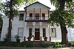 The double-storeyed house, Saxenhof, was formerly also known as Neethling House. The land on which this house stands was granted to Pieter Andriesz Saxe already in 1704. He owned the place for sixteen years and it is accepted that it was he who built the original H-shaped Cape Dutch house. In 1889 the house was sold to Dr. Johannes Henoch Neethling, who shortly after converted the old single-storeyed house into a charming Georgian type double-storeyed house. The original and beautiful old ceilings as well as a few side and back windows of the old house were kept intact.