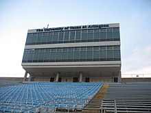 A large, contemporary structure with a text that says "University of Texas at Arlington".