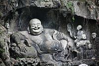 Rock carving of Budai in the grottos
