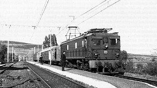 An SNCFA 6-AE locomotive pulling passenger trains at a station on the Bône to Souk Ahras line in 1968.