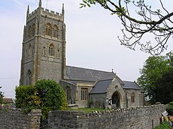 Stone building with prominent square tower.