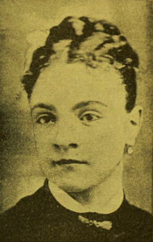 19th-century B&W portrait photo of a woman with her hair in an up-do, wearing a dark blouse, with a white collar.