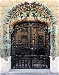 French Art Nouveau - Entrance decorated with glazed tiles of the Les Chardons Building (Rue Eugène-Manuel no. 2), Paris, 1903, by Charles Klein[57]
